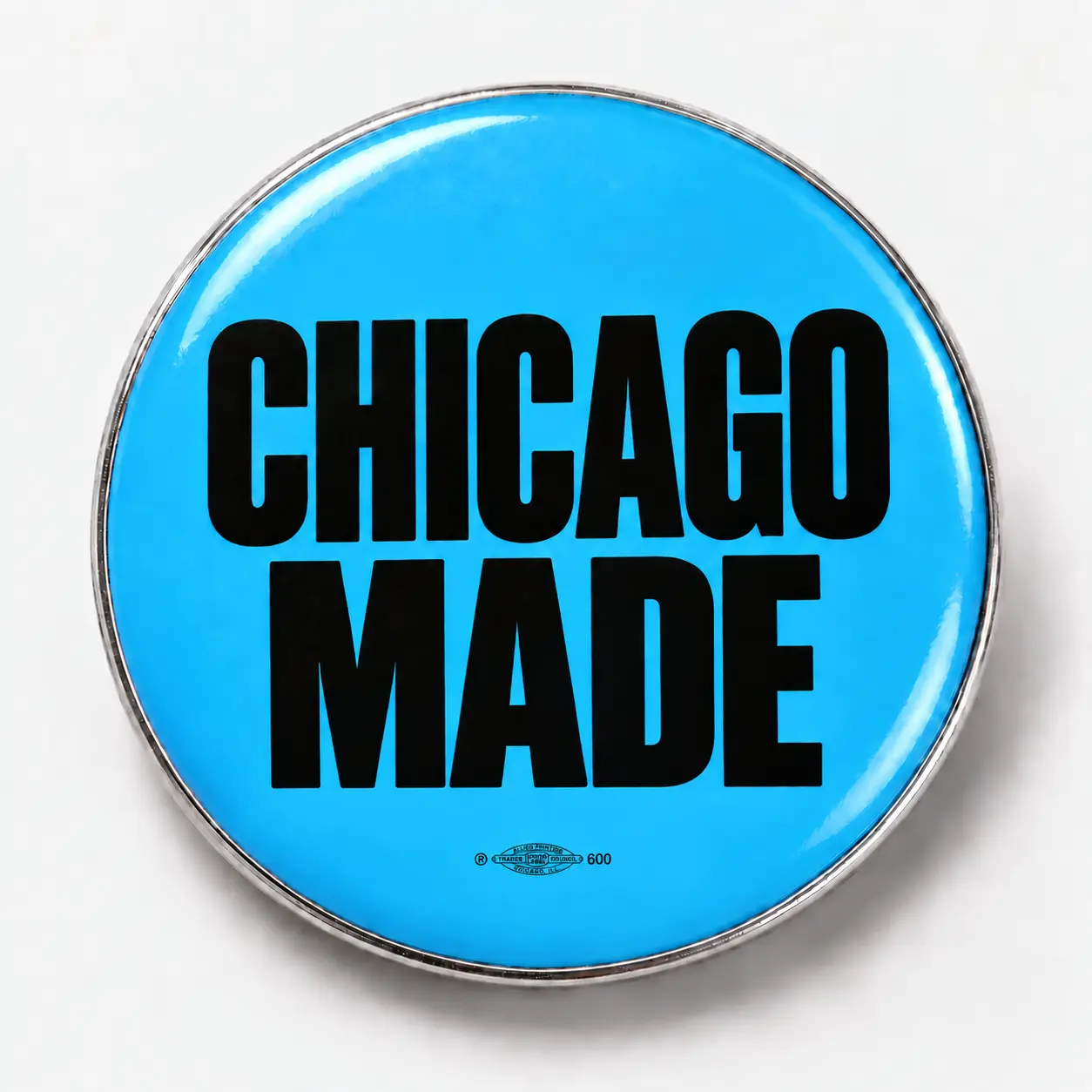 1.25″ round button: illustrative Chicago Made design in blue